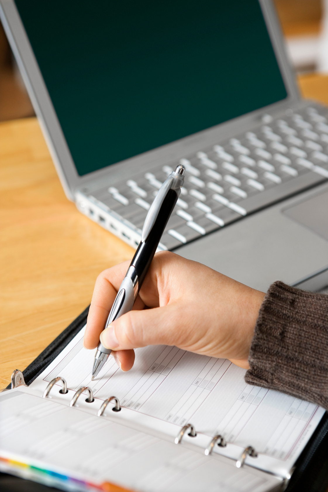 Person writing in appointment book